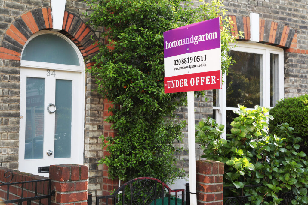 A home with an 'Under Offer' board outside it