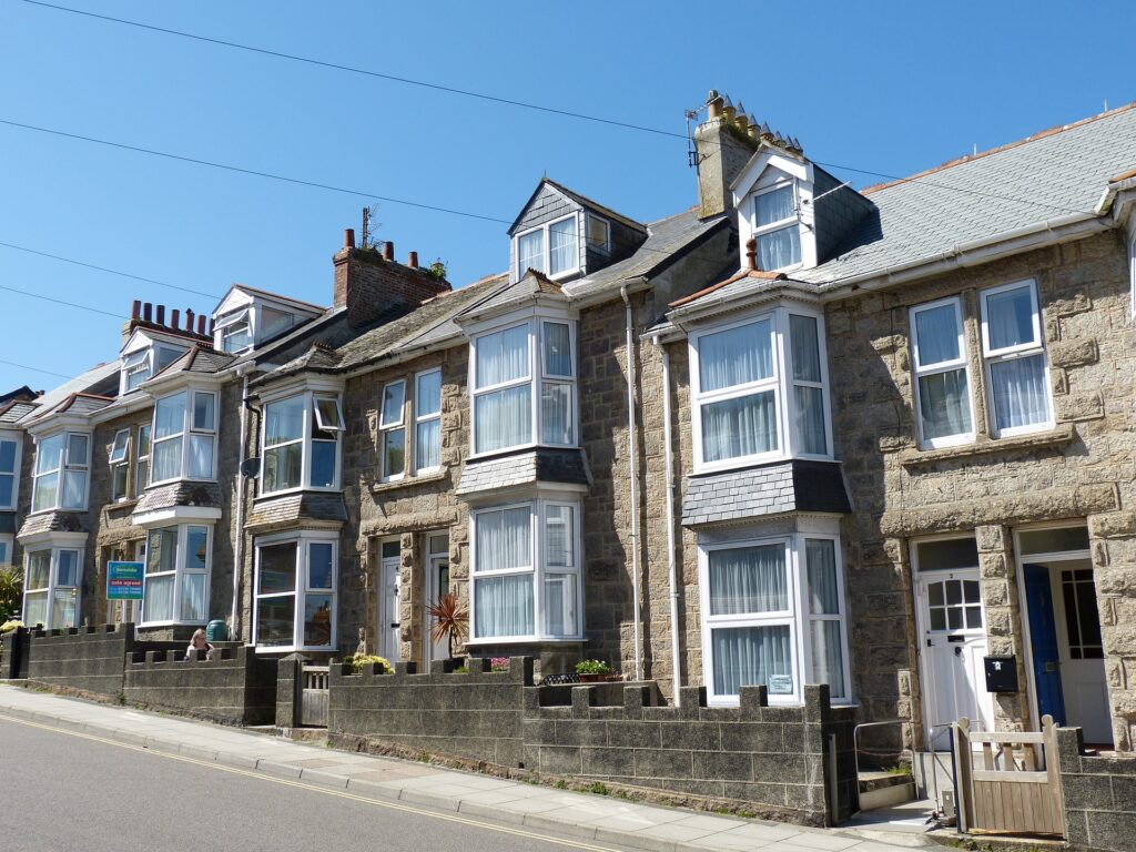 a row of terraced houses in the UK, one with a rental sign